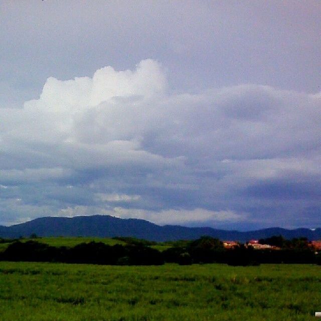 mountain, landscape, sky, tranquil scene, scenics, tranquility, grass, beauty in nature, mountain range, cloud - sky, field, nature, cloudy, green color, non-urban scene, weather, grassy, idyllic, cloud, overcast