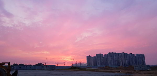 Buildings against sky during sunset