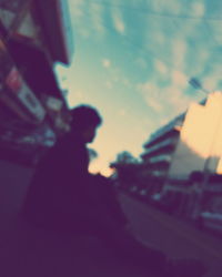 Low angle view of man against sky at sunset