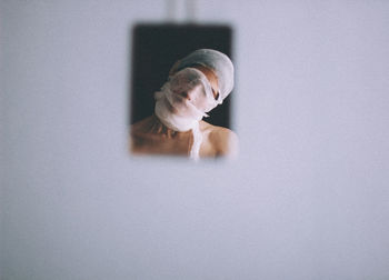 Portrait of man on table against white background