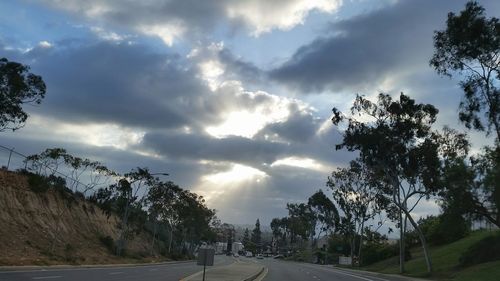 Empty road against cloudy sky