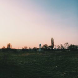 Scenic view of field against sky at sunset