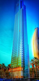 Low angle view of modern building against blue sky
