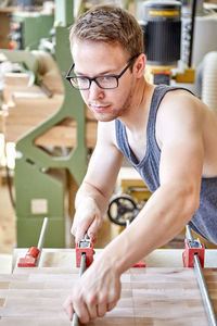 Confident carpenter working in workshop