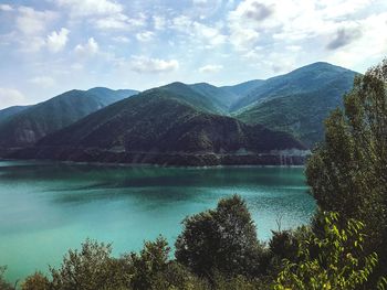 Scenic view of lake against cloudy sky