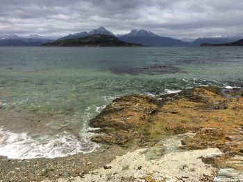 Scenic view of sea and mountains against sky