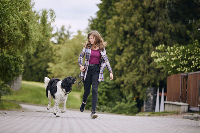 Woman with dog walking in park