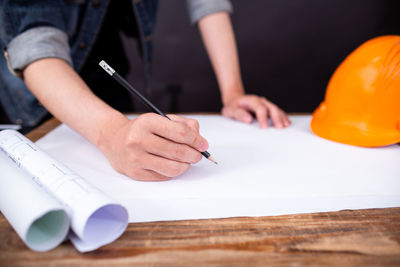 Midsection of man working on table