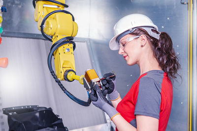 Technician working on machinery in factory