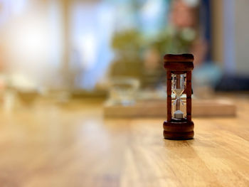 Close-up of clock on table at home