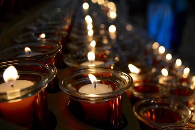 Close-up of lit tea light candles in temple