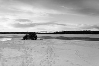 Scenic view of frozen lake against sky during winter