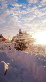 Snow covered field against sky