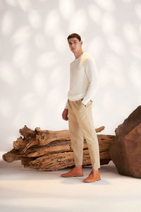 Portrait of young woman standing on rock