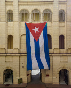 Low angle view of flag against building