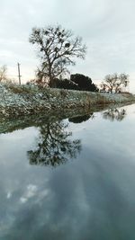 Scenic view of lake against sky during winter