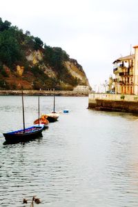 Boats moored on sea against sky
