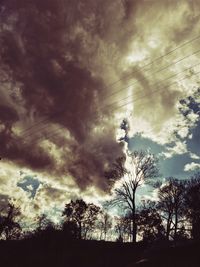 Low angle view of silhouette trees against sky during sunset