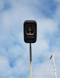 Low angle view of telephone pole against sky