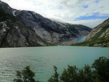 Scenic view of lake and mountains against sky