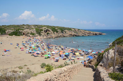 People on beach against sky