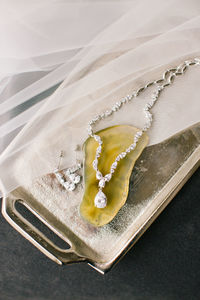 Tray and diamond necklace with yellow gemstone.