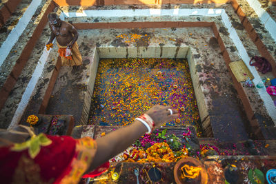 High angle view of hands on multi colored temple