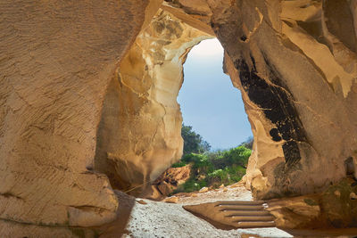 View of rock formations through cave
