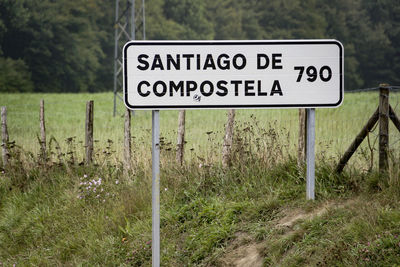 Close-up of sign board on field