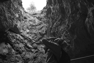 Low angle view of woman standing in cave