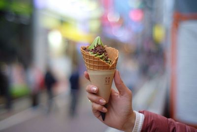 Close-up of hand holding ice cream cone