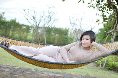 Portrait of young woman relaxing outdoors