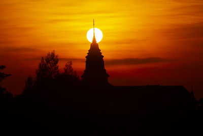 Silhouette of building during sunset