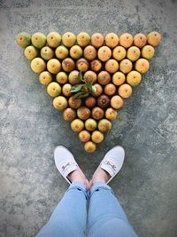 Low section of person standing on fruit