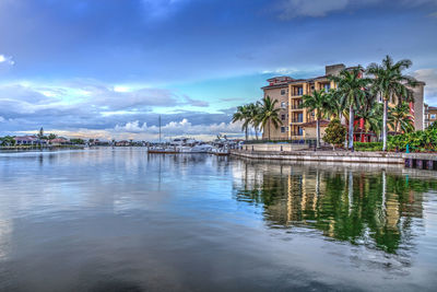 Scenic view of lake and buildings against sky