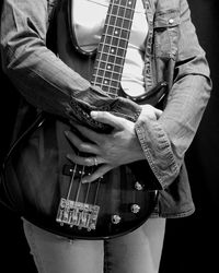 Midsection of woman holding guitar