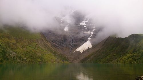 Scenic view of lake and mountains against sky