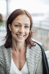 Portrait of happy mature businesswoman at restaurant