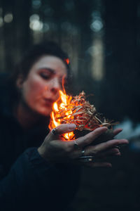 Close-up of woman with fire