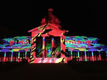 Low angle view of illuminated building against sky at night