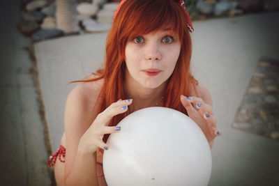 Close-up portrait of young woman standing outdoors
