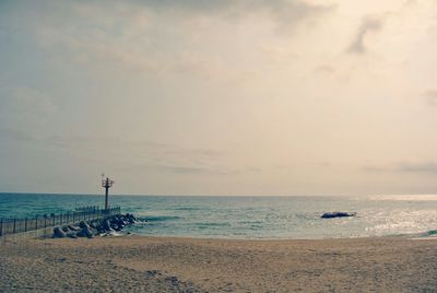 Scenic view of sea against cloudy sky