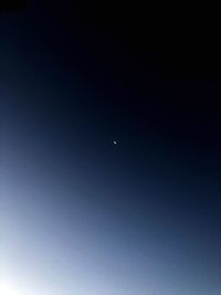 Low angle view of moon against clear sky at night