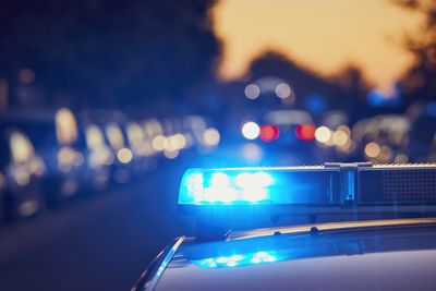 Siren light on roof of police car at night street. themes crime, emergency and help.