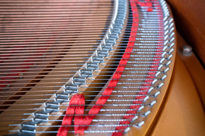 Close up image of interior of grand piano showing strings and structure