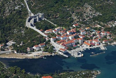 High angle view of buildings and trees in city