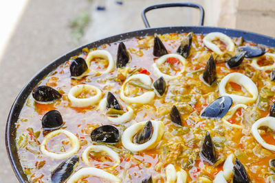 Cooking typical spanish seafood paella in a stove