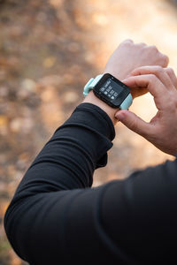 Girl checking smart watch with fitness tracker, looking at health data while exercising