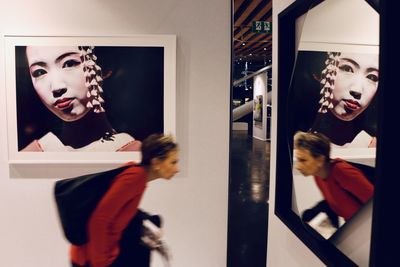 Portrait of young woman standing in store