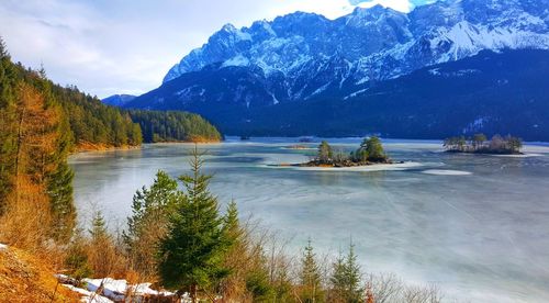 Scenic view of lake and mountains against sky